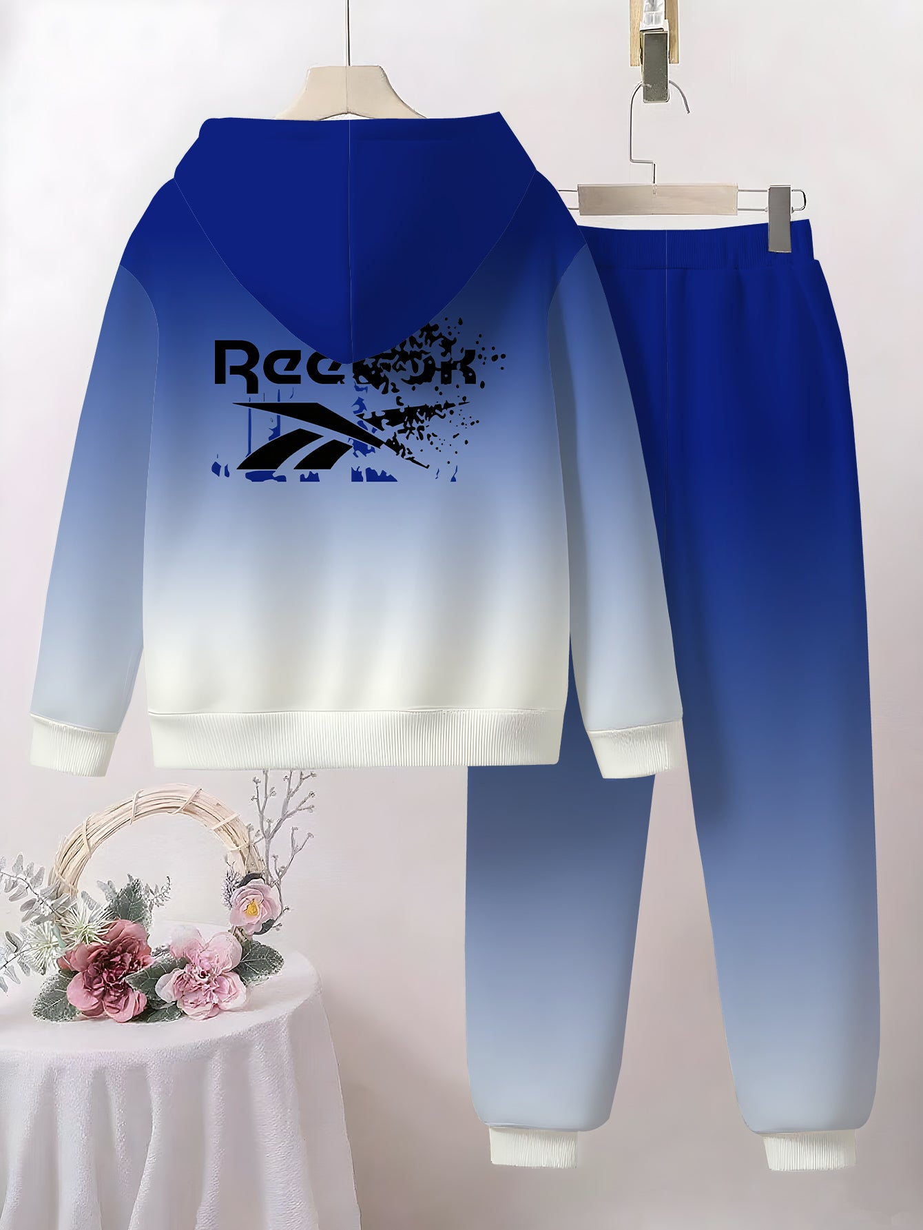 Boys' Gradient Hooded Tracksuit Set. This two- piece casual sportswear features a blue- white gradient. It's a themed hooded tracksuit set that showcases a sporty style, making it a trendy and comfortable choice for boys in s